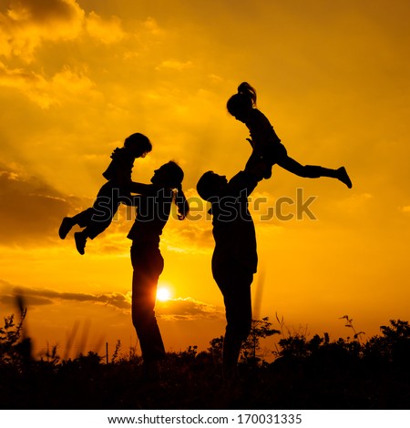 Happy  family playing on the  road in the  sunset time. Evening party on the nature