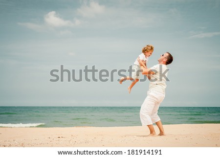 father and son playing at the beach in the day time father and son playing at the beach in the day time