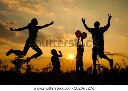 Happy  family playing with balloons on the  road in the  sunset time. Evening party on the nature