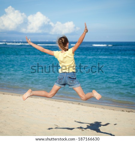 flying jumping beach girl at blue sea shore in summer vacation in the day time