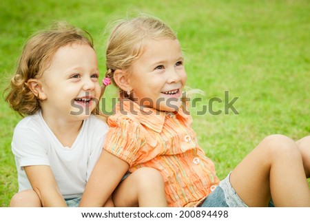 Happy kids sitting on the grass. Concept Brother And Sister Together Forever