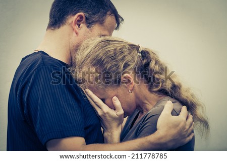 Sad woman hugging her husband