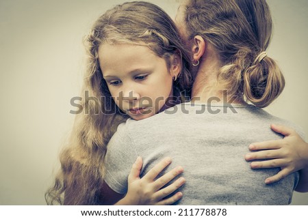 portrait of one sad daughter hugging his mom