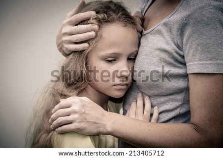 portrait of one sad daughter hugging his mom