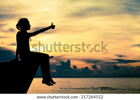 happy teen girl sitting on beach at the dawn time happy teen girl sitting on beach at the dawn time