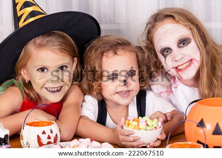 Happy brother and two sisters on  Halloween party