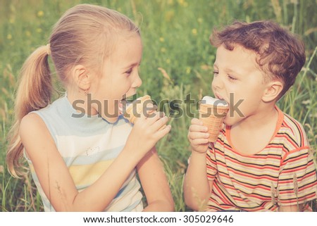 Two happy children  playing in the park at the day time. Concept Brother And Sister Together Forever