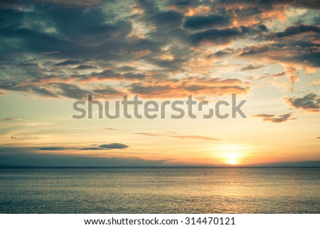 Sunset on the beach with cloudy sky
