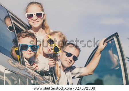 Happy family getting ready for road trip on a sunny day.  Concept of friendly family.
