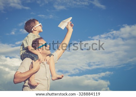 Father and son playing in the park  at the day time. Concept of friendly family.