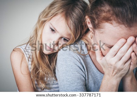 sad daughter hugging his mother at home. Concept of couple family is in sorrow.