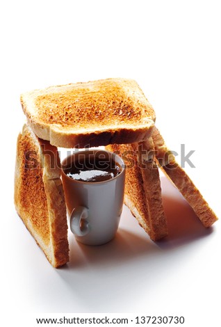 Cup of coffee and toast arranged in the shape of house. Conceptual photo