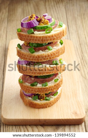Sandwiches with sausage on a cutting board closeup