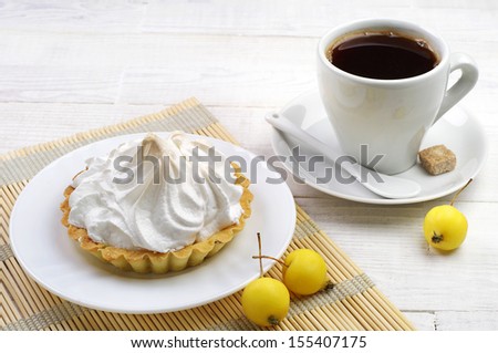 Cup of coffee and cake with apple on table