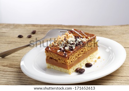 Cake with nuts and chocolate on wooden table