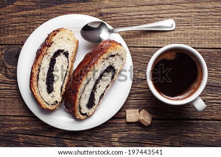 Poppy seed cake and cup of coffee on wooden table