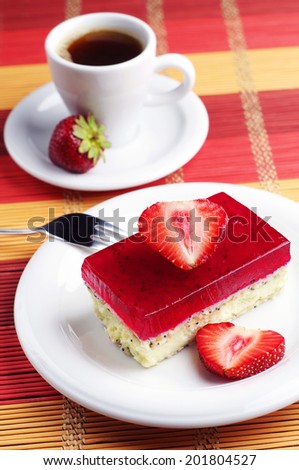 Delicious strawberry cake with poppy and cup of coffee on bamboo napkin