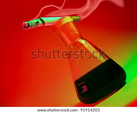 Cigarette and flask with nicotine