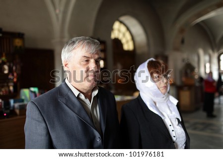 The mature couple in russian orthodox church