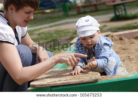 Mother points to her child on his dirty hand