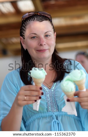 Portrait of woman with ice cream in a cafe