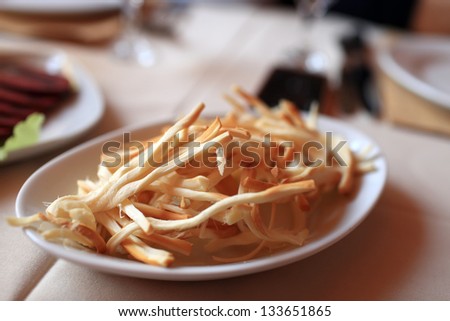 Chechil string cheese on a white plate in a pub