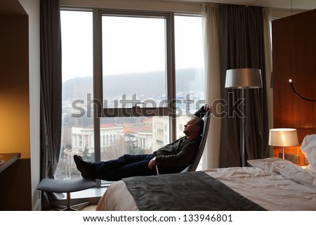 The tourist is resting in hotel room