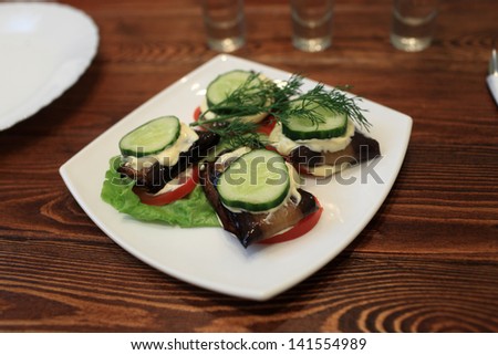 Plate of vegetables on a wooden table in the restaurant