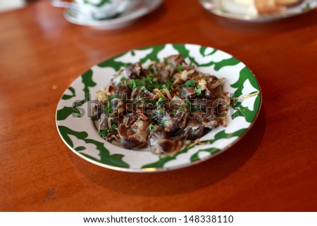 Stewed giblets on the plate in a restaurant