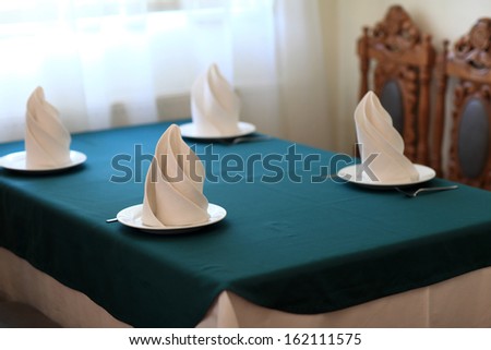 Table setting for four persons in the restaurant