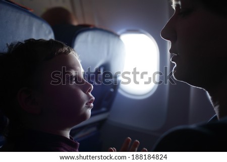 Son listening to his mother at an airplane
