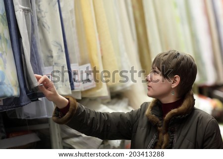 Woman choosing fabrics in a drapery shop