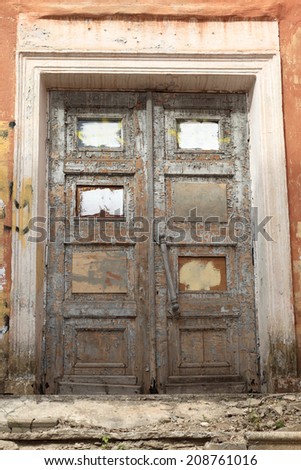 Fragment of the old ruined wooden door as background