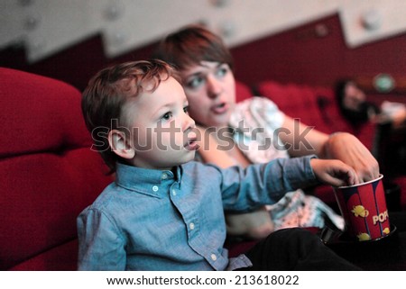 The family eating popcorn in the cinema