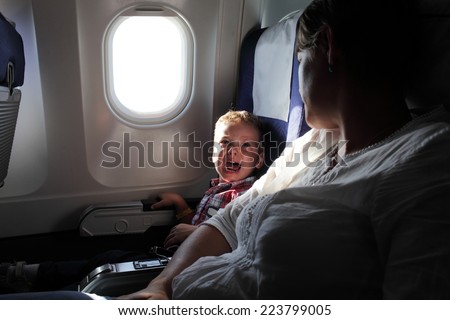 Portrait of the crying boy on the flight