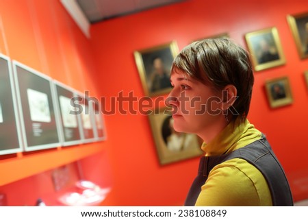 Tourist looking at a picture at the exhibition
