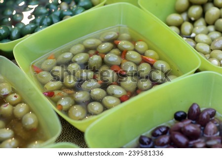 Stuffed green olives in the boxes at a market