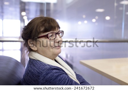 Portrait of senior woman in restaurant at airport