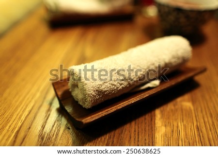 Wet towel on the wooden plate in the restaurant