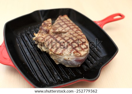 Cooking of beef blade steak on cast-iron grill pan