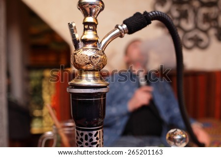 Person smoking nargile in the asian restaurant