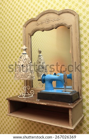 Details of the vintage interior. Retro sewing machine and a mirror