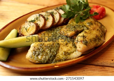 Fried fillet of sea bass with potatoes and lemon-garlic sauce