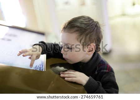 Boy using touch screen in the museum