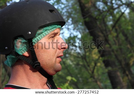 Portrait of the man with helmet in the park