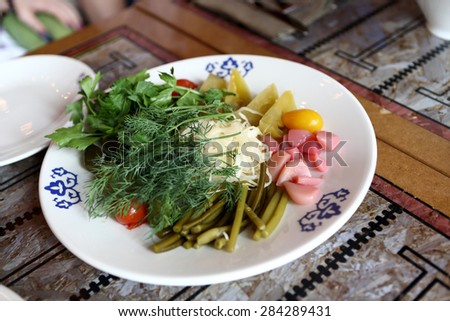 Plate with pickled vegetables in the russian restaurant