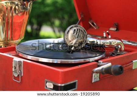 The retro portable gramophone with disc, outdoor