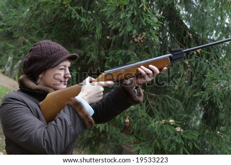 The woman aiming a pneumatic air rifle