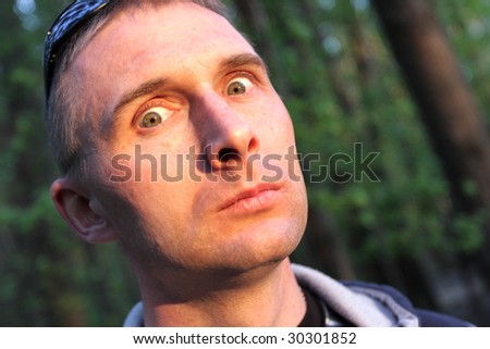The frightened man in spring forest on sunset