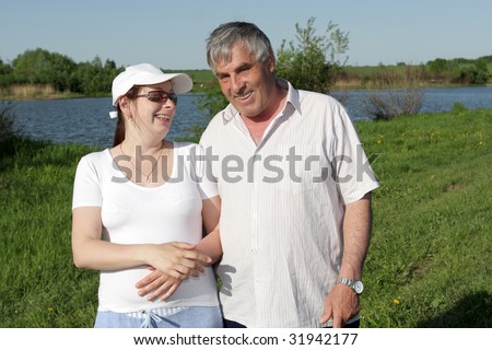 The young woman and her father poses in summer